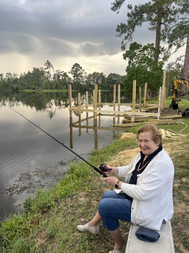 Sara Walker trying to catch a fish while others work on the doc