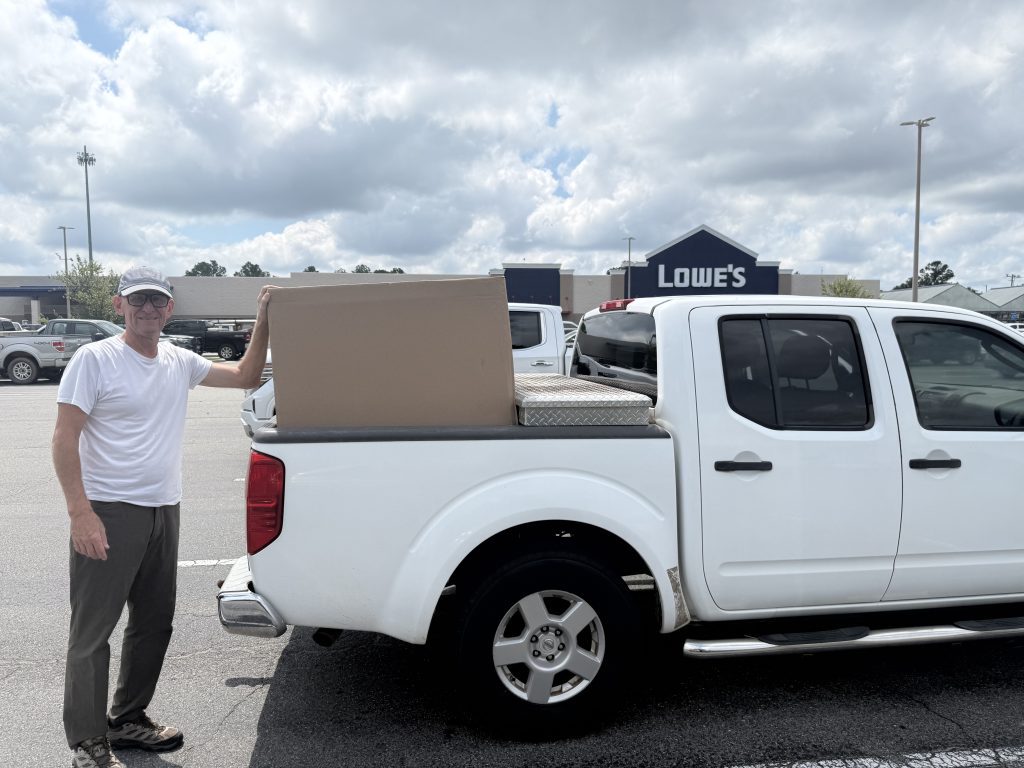 Jimmy loading countertops onto a flat cart in the aisle at Lowe's